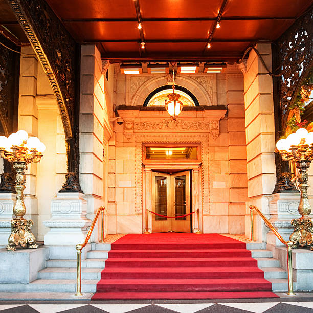 Marble steps covered with red carpet leading to the rope barrier and closed door